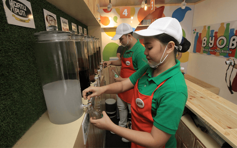 NutriAsia Employee refilling bottles